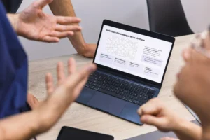 Laptop and hands of people