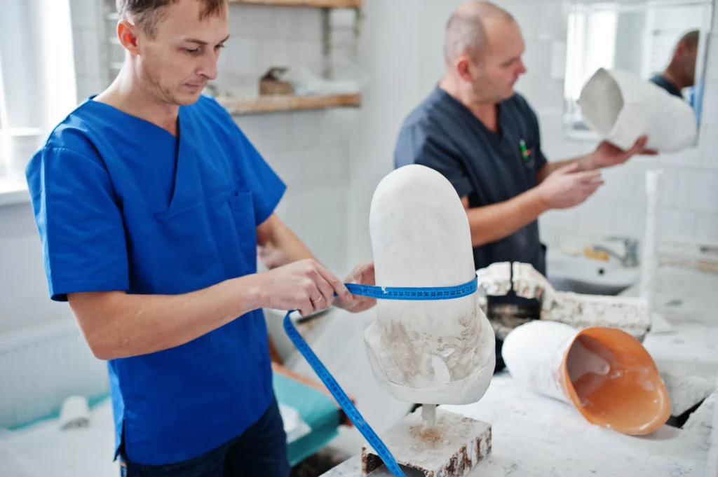 two-prosthetist-man-workers-making-prosthetic-leg-while-working-laboratory_11zon